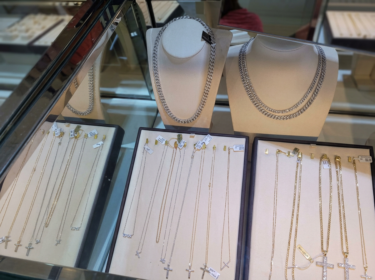 Silver chains and pendant necklaces displayed in the store
